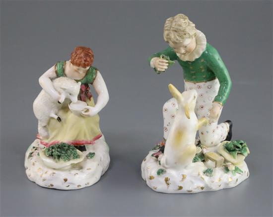 A pair of Rockingham porcelain groups of a boy feeding a rabbit and a girl seated with a lamb, c.1830, h. 14cm and 10.5cm, some faults